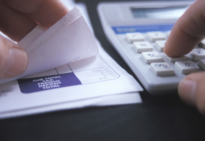 Tax agent calculating finances and a income tax return.