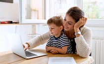 Mother and son using a laptop.