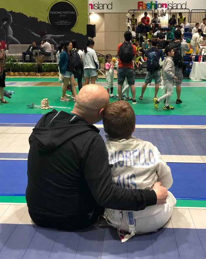 Father and son at fencing competition