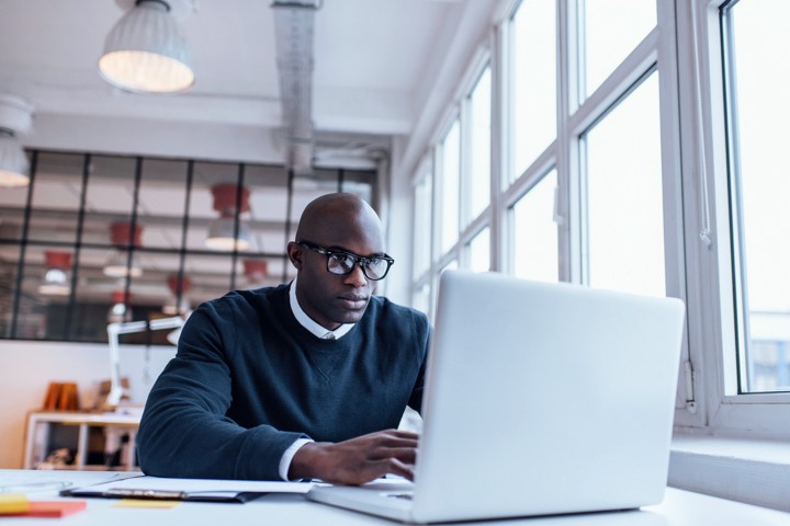 Man transferring files online using his laptop.