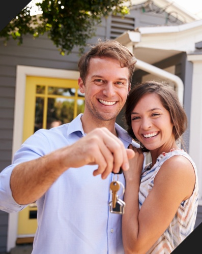 Couple with keys to their new home.