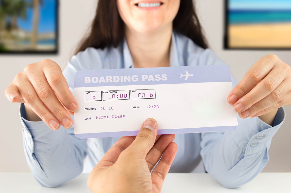 Travel agent handing over boarding pass