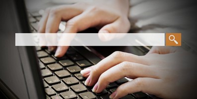 Woman typing on their laptop to search for things.