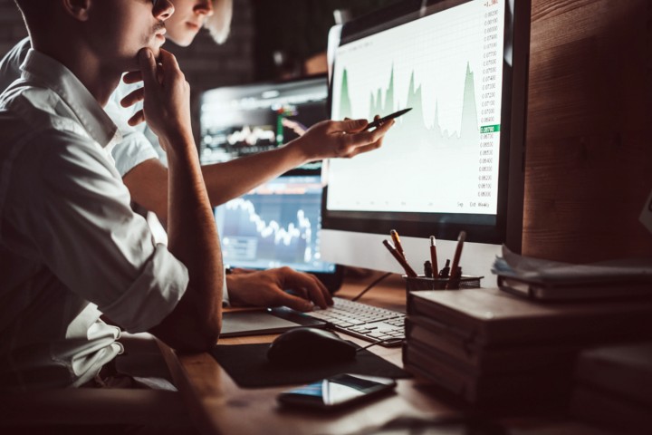 Two people reviewing investments.