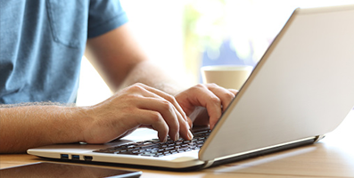 Woman typing on their laptop to search for things.