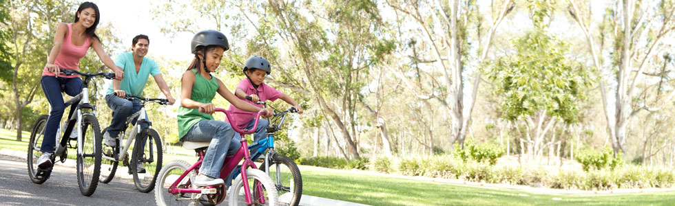 A relaxed family riding pushbikes.