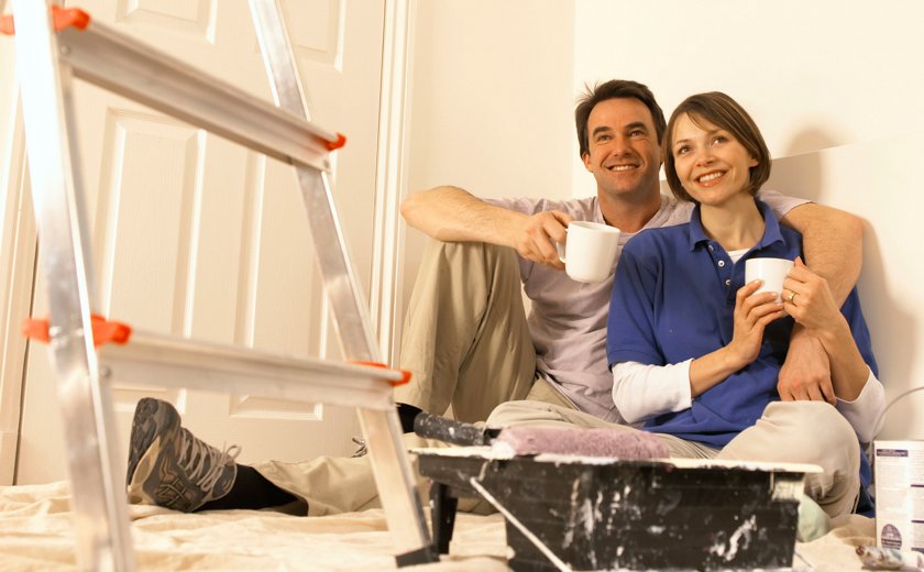 Happy home owners, working on their home.